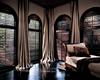 Deep Chocolate Stained Wood Plantation Shutters -- Arched Windows with puddled drapery panels -- Palm Beach Gardens Florida