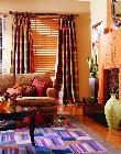 Colorfull casual draperies puddled to floor over wooden horizontal blinds -- Jupiter Florida Home