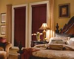 Horizontal Faux Wood Blinds in walnut feature predominantly in this traditional bedroom in Royal Palm Beach Florida