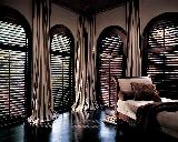 Lake Worth Florida Residence Stained Plantation Shutters/Blinds with Striped Drapery Window Panels