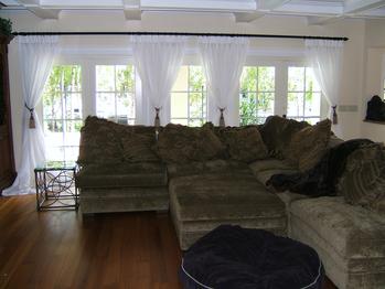 Tieback sheers drape with panels in Palm Beach Gardens home